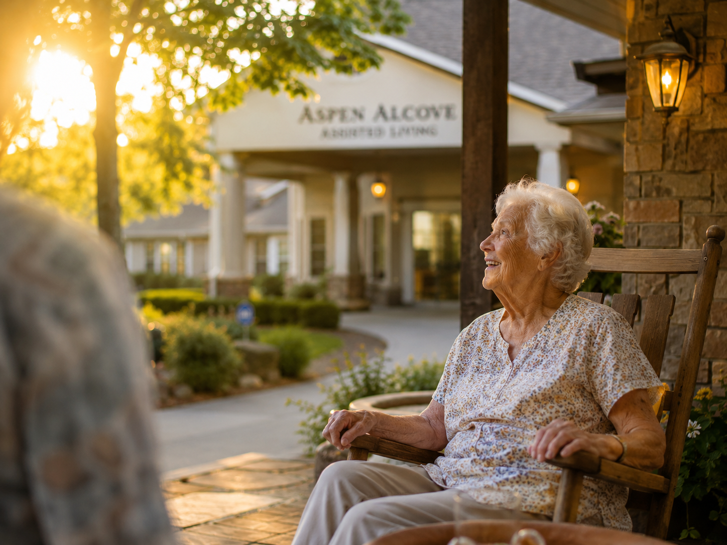 A welcoming Kentucky senior living front porch among mature trees in warm afternoon light.