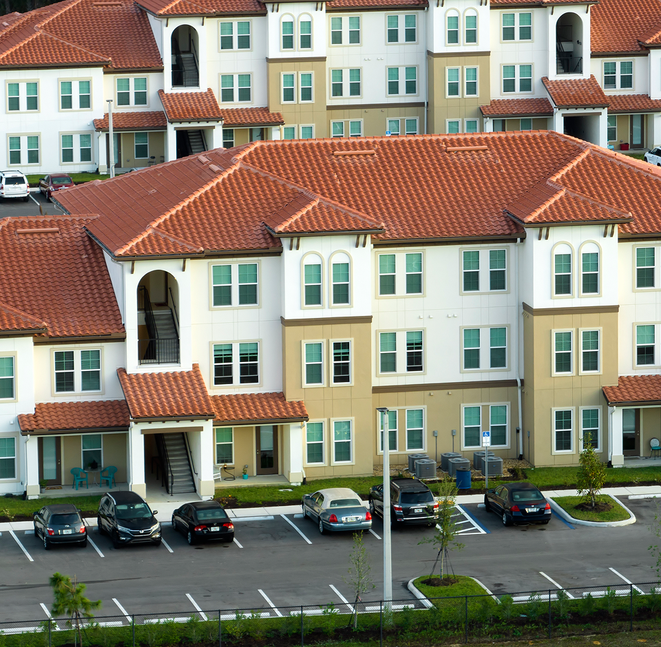 Aerial view of a senior living community surrounded by trees and landscaped grounds.