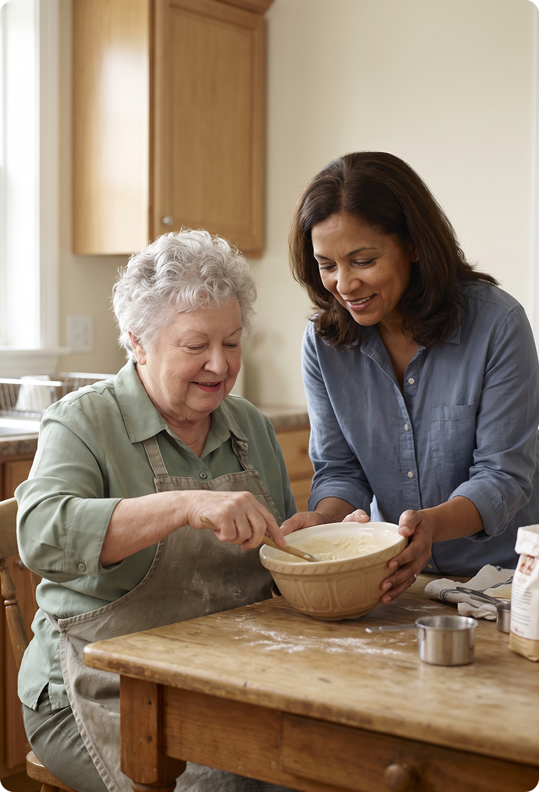 A grandmother and granddaughter laugh together while baking in a sunlit kitchen.