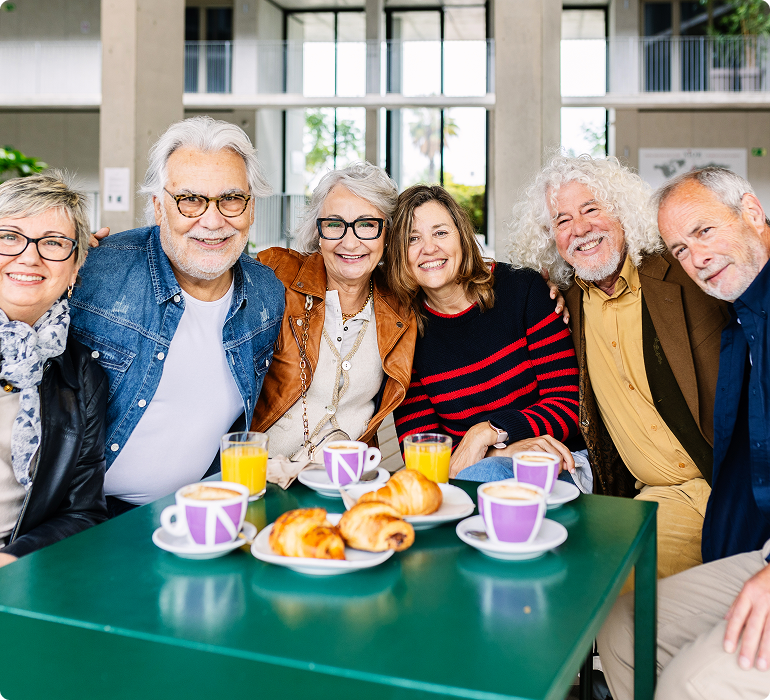 Residents share a warm conversation in a bright community living space.